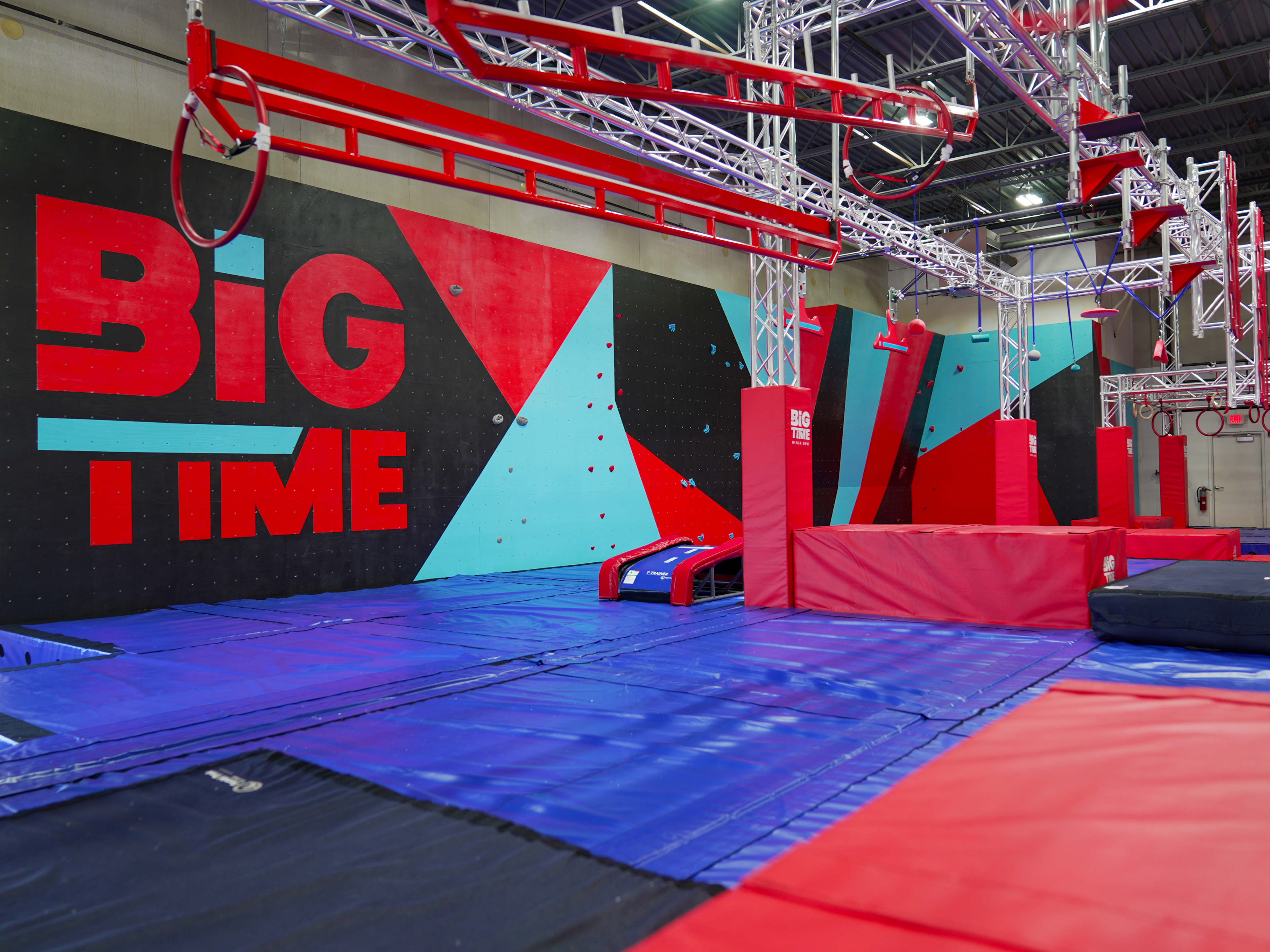 Colorful ninja warrior obstacle course equipment inside the Big Time Ninja gym